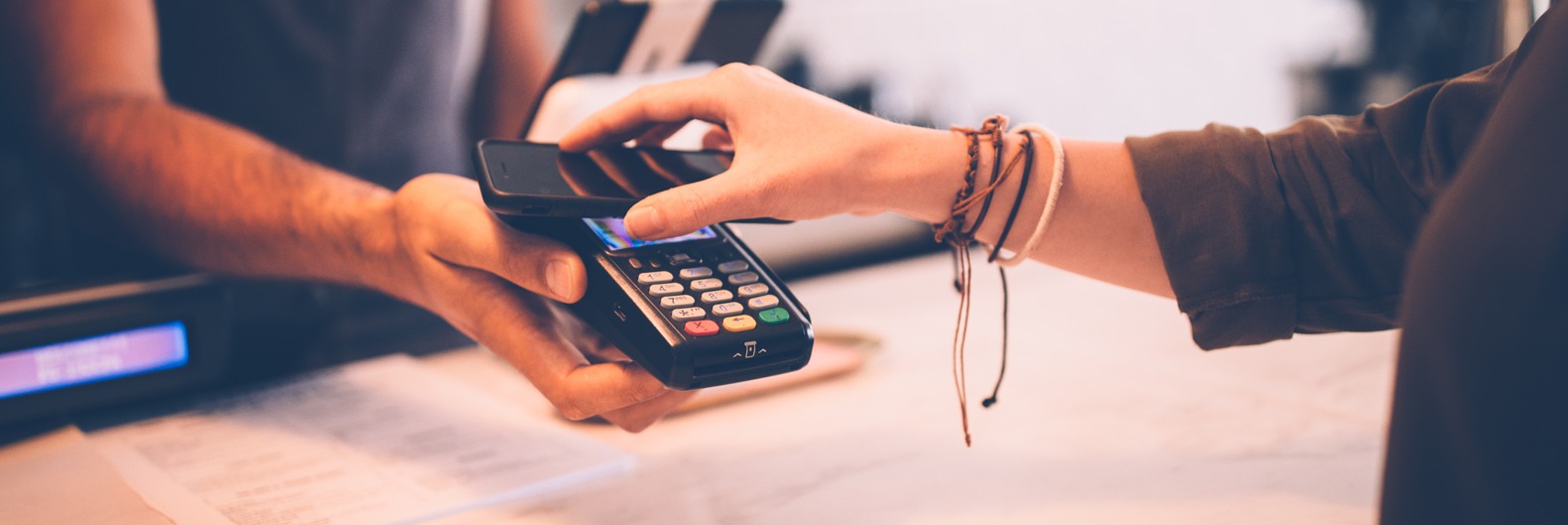 Woman making a payment with her mobile device